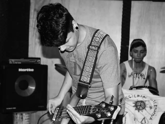 Father places son at the podium, showcasing son's impressive baton dexterity on the conductor's...