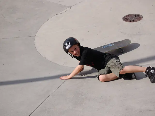 In this picture we can see a kid is smiling, he wore a helmet and shoes, we can see a skateboard in...