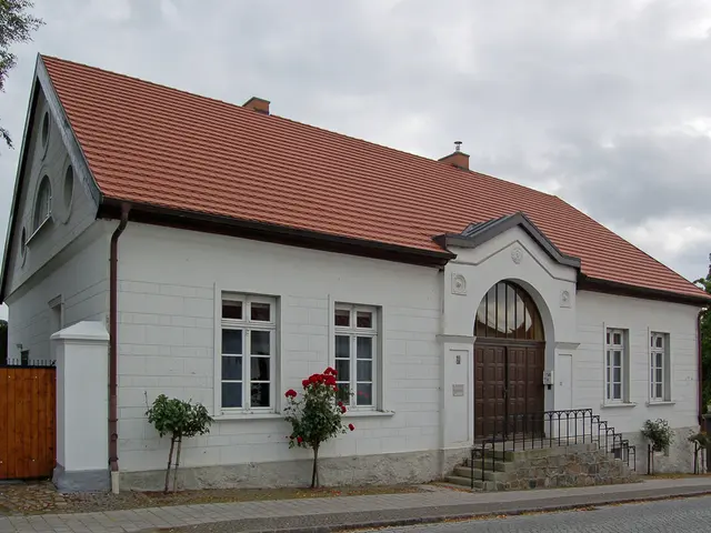 At the bottom of the image there is a footpath. On the footpath there are plants and also there are...