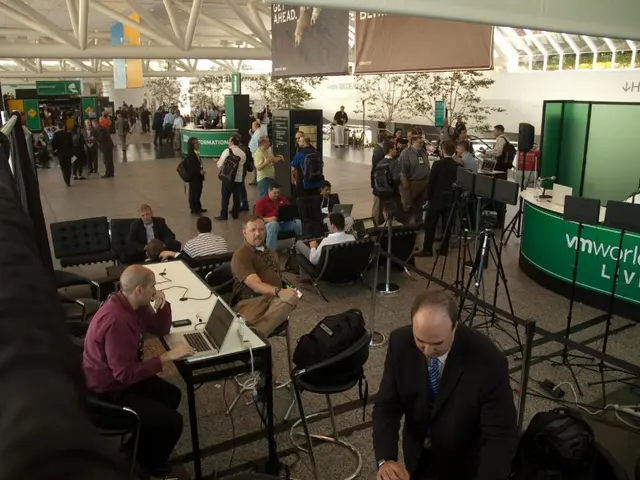 Here in this picture we can see number of people standing, sitting and walking in the floor over...