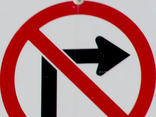 In this picture I can observe ¨No turn right¨ sign on the board. The background is in white color.