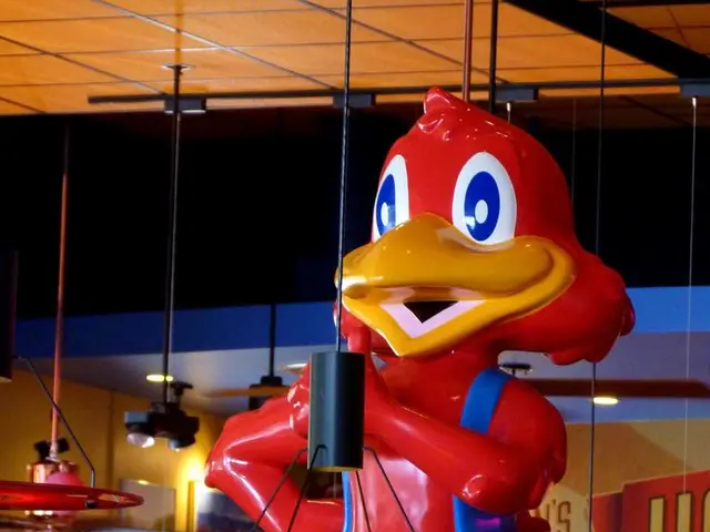 There is a toy. At the bottom there is a pot with plant, bottles, poster with something written on...