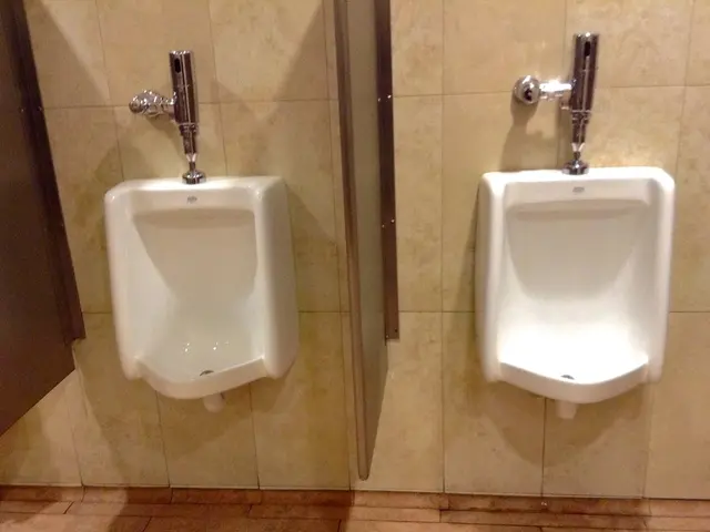 In this image I can see two toilets in white color and I can also see two flushes attached to the...